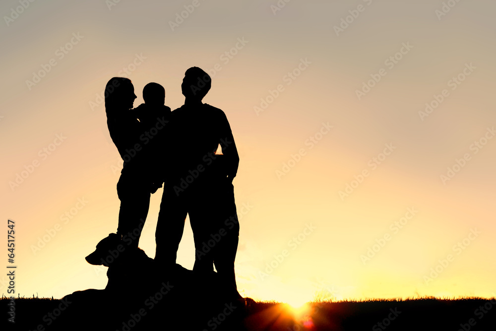Happy Young Family and Dog Silhouette at Sunset Happy Young Family and Dog Silhouette at Sunset
