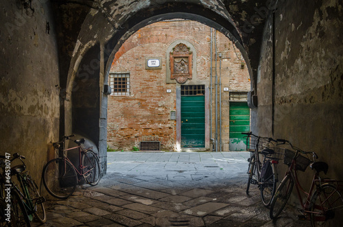 Lucca (Italy): bikes under a porch and coloured doors