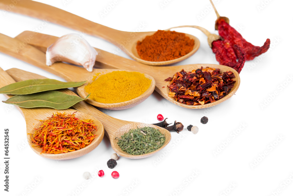 Colorful spices in wooden spoons Colorful spices in wooden spoons