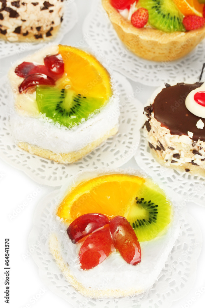 sweet cakes with fruits and chocolate isolated on white sweet cakes with fruits and chocolate isolated on white
