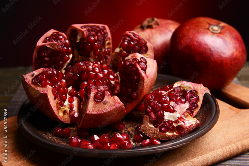 Ripe pomegranates on table close-up Ripe pomegranates on table close-up