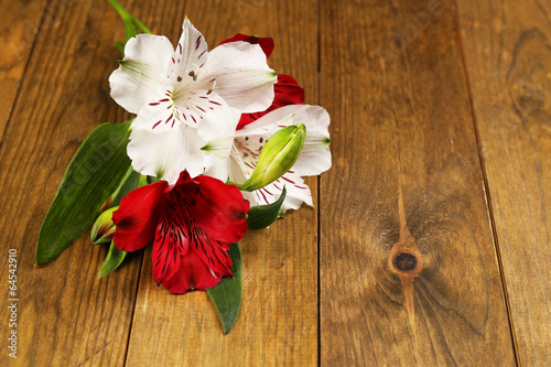 Fototapeta Naklejka Na Ścianę i Meble -  Beautiful Alstroemeria flowers on wooden table