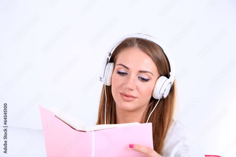 Conceptual image of audio book. Beautiful girl with book and Conceptual image of audio book. Beautiful girl with book and