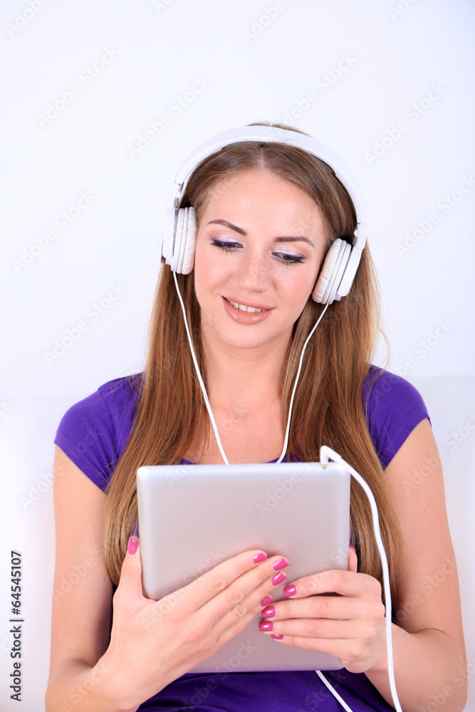 Beautiful girl with PC tablet and headphones. Beautiful girl with PC tablet and headphones.