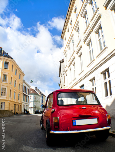 Old red car in a street © socrep