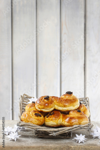 Traditional swedish buns in wicker basket. A saffron bun photo