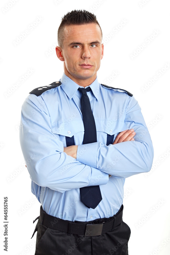 Portrait of young strict man standing in police uniform Portrait of young strict man standing in police uniform