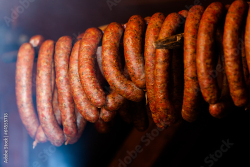 Traditional food. Smoked sausuages in smokehouse.