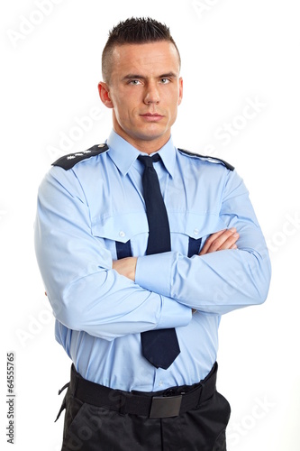Portrait of young strict man standing in police uniform