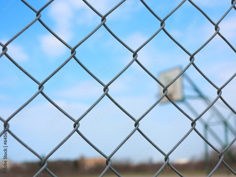 Metal mesh with blur basketball court background Metal mesh with blur basketball court background