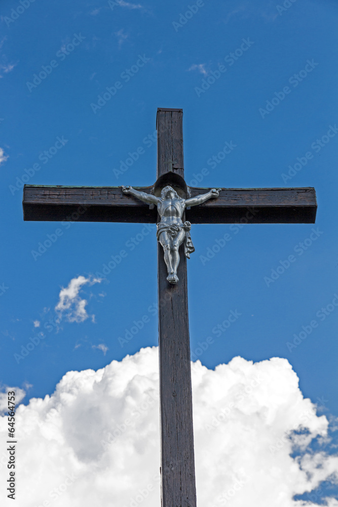 wooden christian cross in the background of blue sky