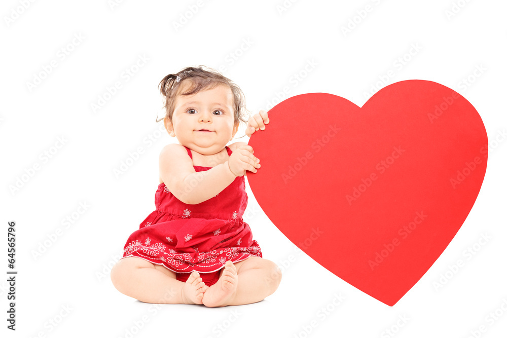 Cute little baby holding a big red heart Cute little baby holding a big red heart