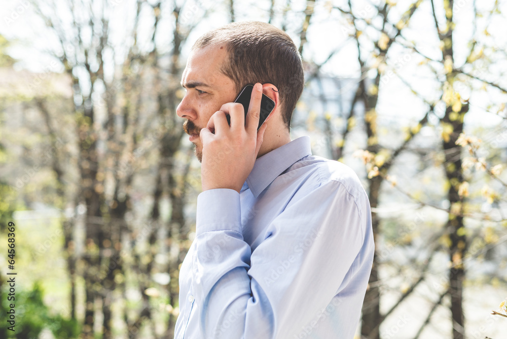 elegant business multitasking multimedia man calling with smartp elegant business multitasking multimedia man calling with smartp