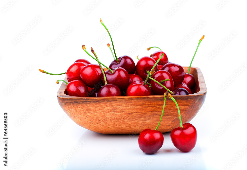 cherry berry in wooden bowl, isolated on white background cherry berry in wooden bowl, isolated on white background