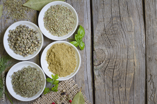 Herbs and dried spices on wooden board