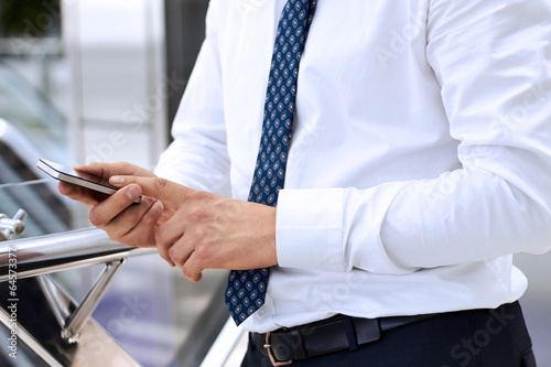 Businessman holding the mobile phone