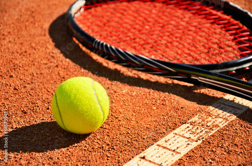 tennis ball and racket is on the carpet court closeup
