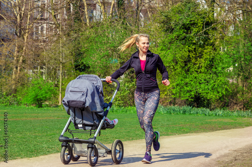 Smiling woman pushing baby buggy