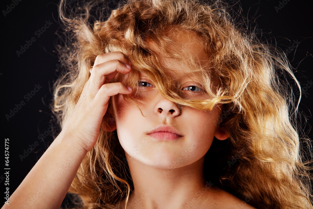 Fototapeta premium Portrait of beautiful little girl with windy hair. Fashion photo