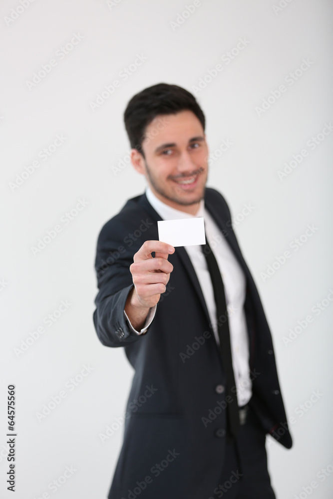 Smiling businessman giving businesscard to client Smiling businessman giving businesscard to client