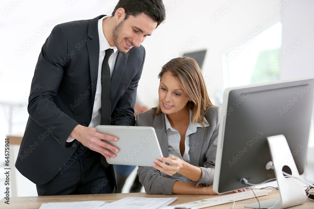 Business people in office working on tablet Business people in office working on tablet