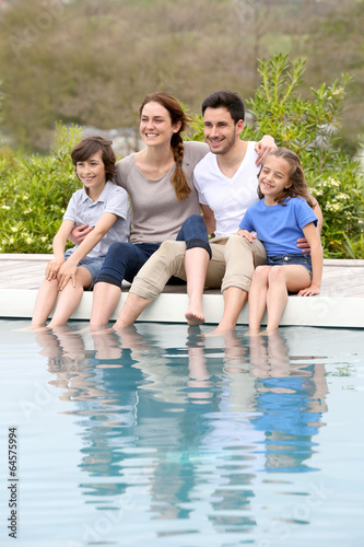 Parents with children relaxing by the pool