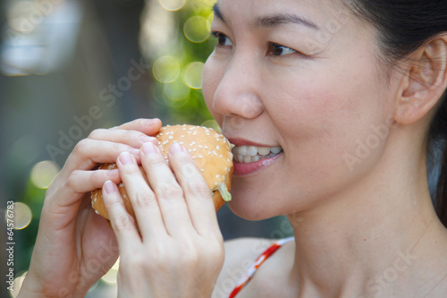 Woman eating a hamburger