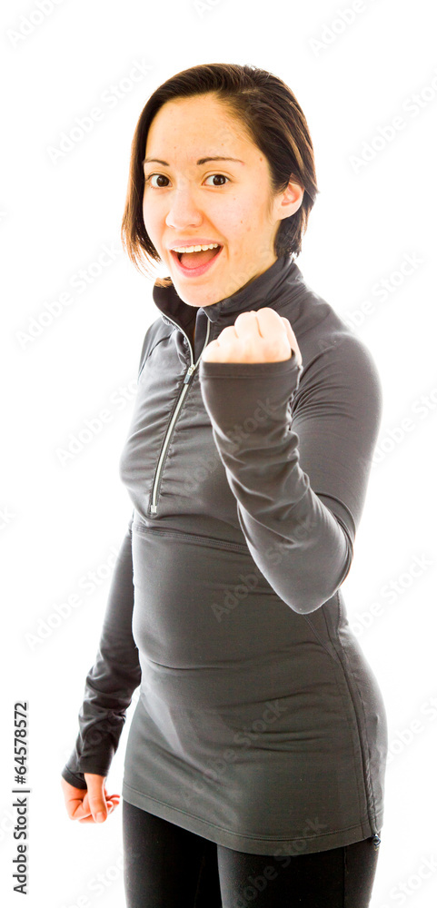 Young woman punching the air and smiling Young woman punching the air and smiling