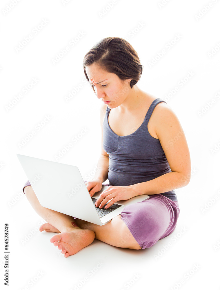 Young woman sitting on floor using laptop Young woman sitting on floor using laptop
