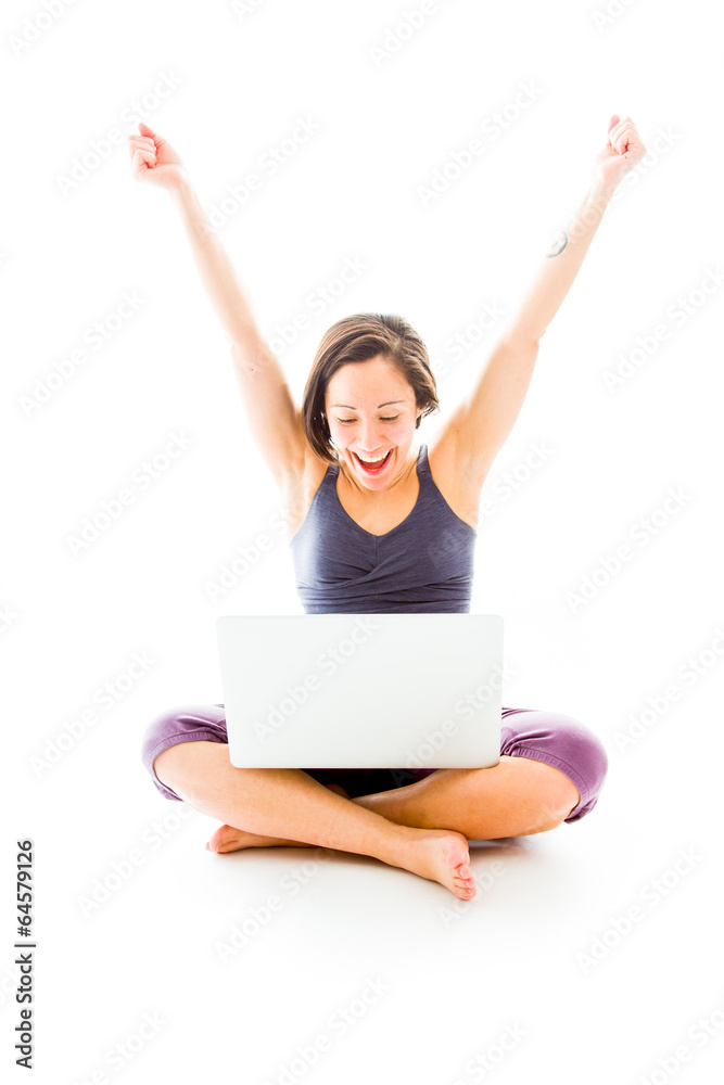 Young man using laptop with arms raised Young man using laptop with arms raised