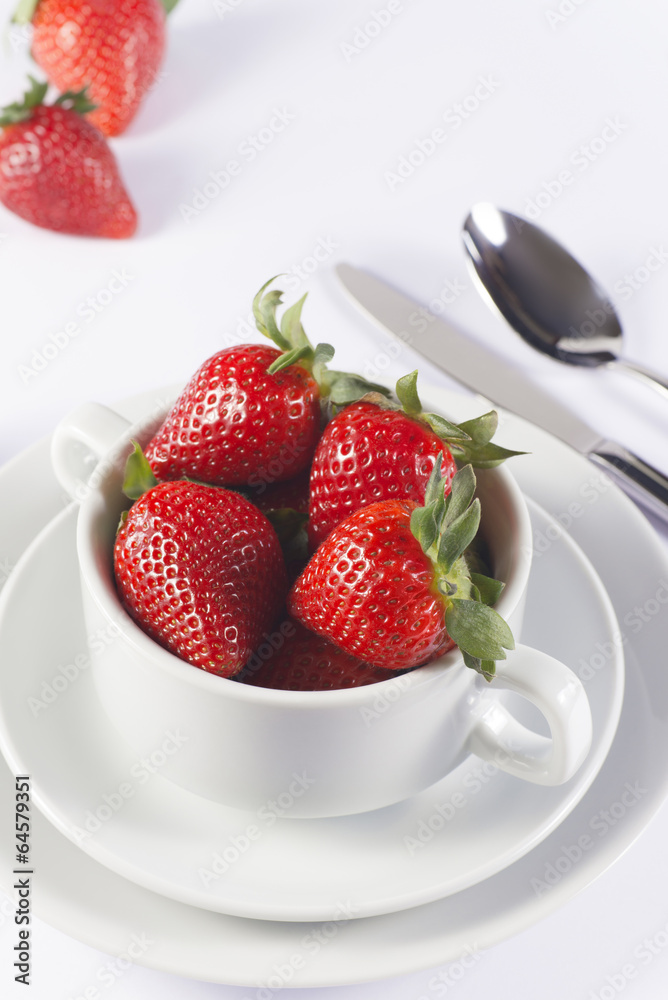 Festive table set with strawberry in bowl on white background Festive table set with strawberry in bowl on white background
