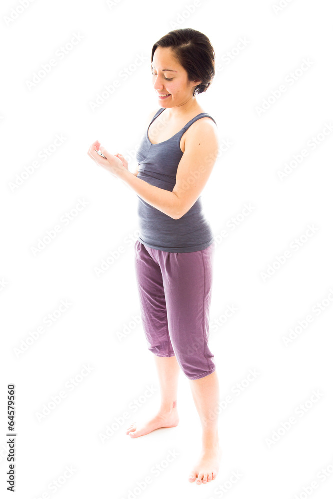 Young woman text messaging on mobile phone and smiling Young woman text messaging on mobile phone and smiling