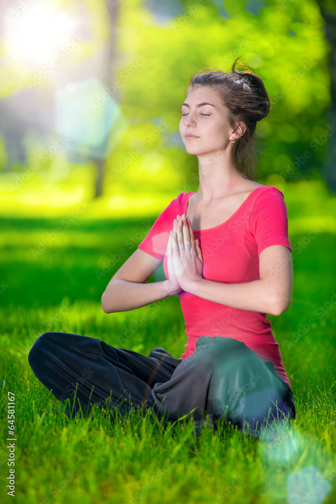 Young woman doing yoga exercises