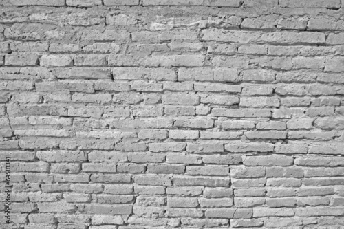 Vintage white brick wall with cracked concrete