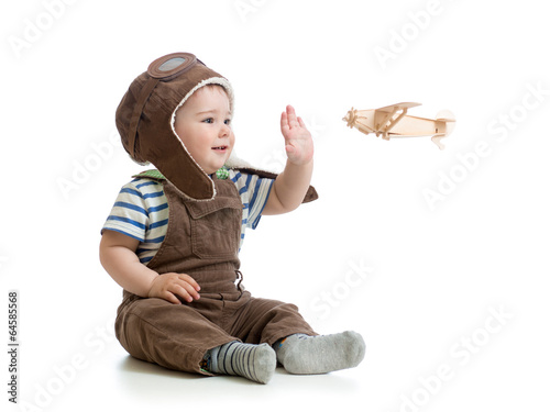 child boy playing with wooden plane photo