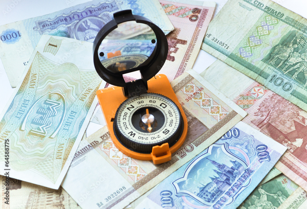 Banknotes and compass. Navigation in the world of Finance. Banknotes and compass. Navigation in the world of Finance.