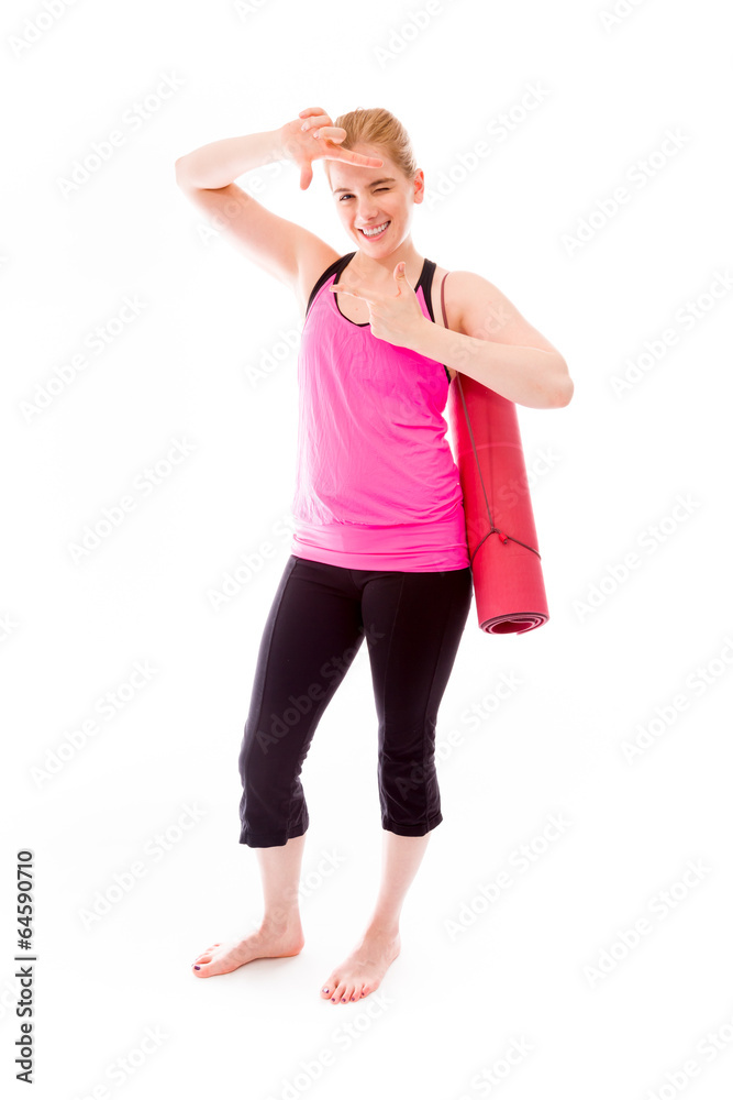 Young woman carrying exercising mat making frame with fingers Young woman carrying exercising mat making frame with fingers