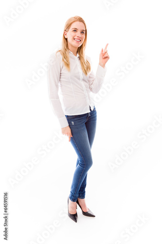 Young woman pointing upward and smiling