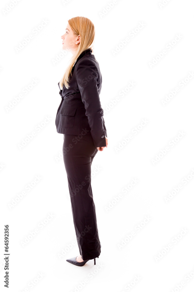 Profile of a businesswoman standing with hands behind back Profile of a businesswoman standing with hands behind back