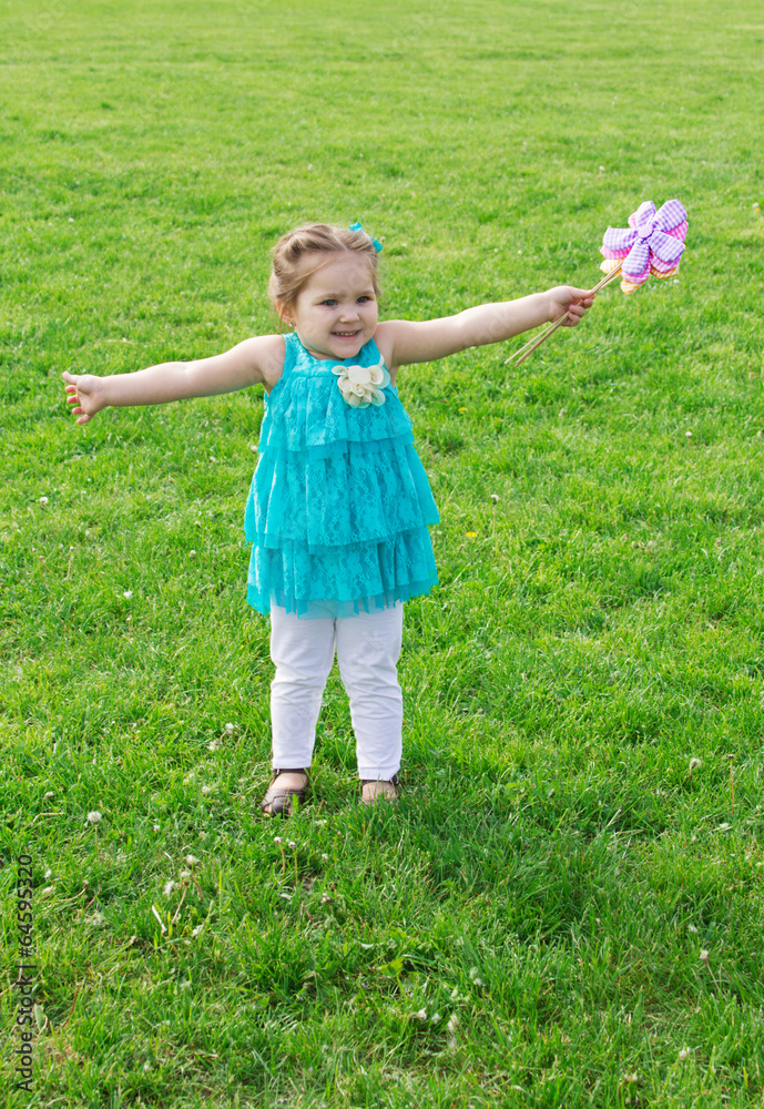 Little girl among green meadow with flowers Little girl among green meadow with flowers