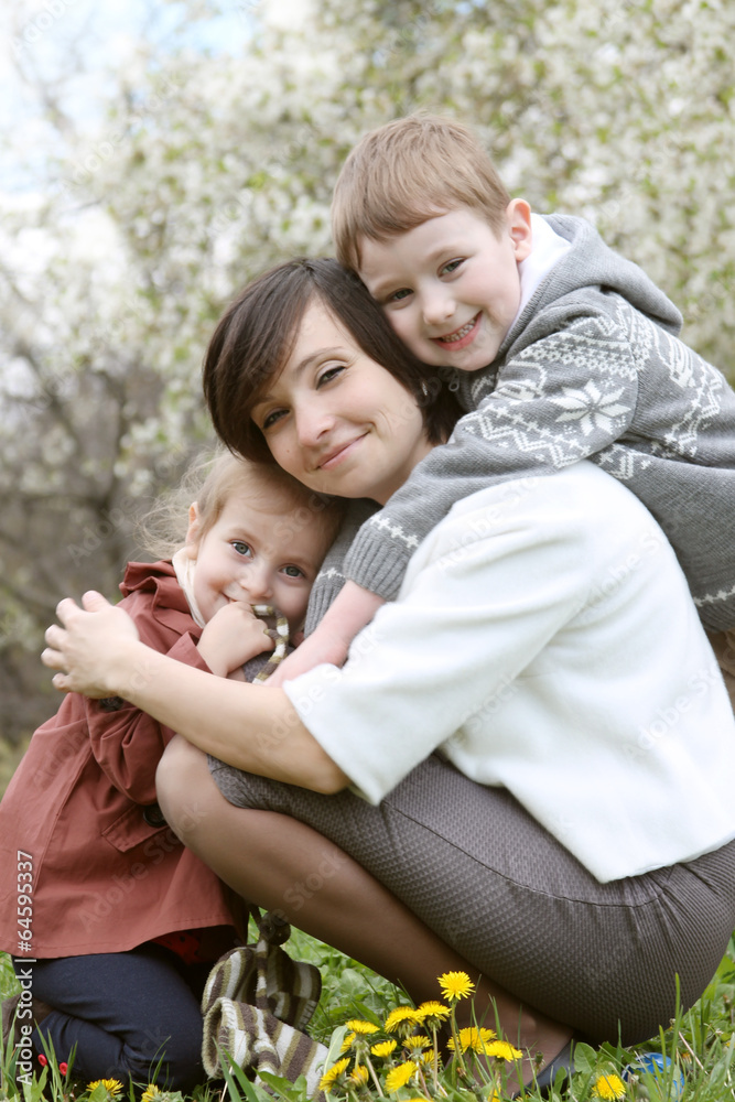 Happy mother and two children hugging Happy mother and two children hugging