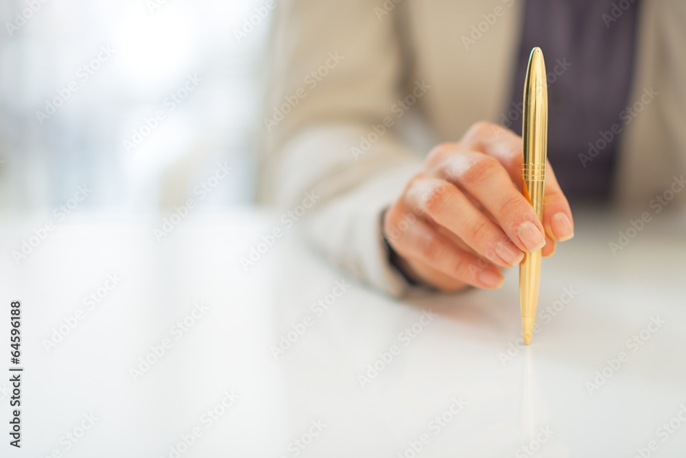 Closeup on business woman holding pen Closeup on business woman holding pen