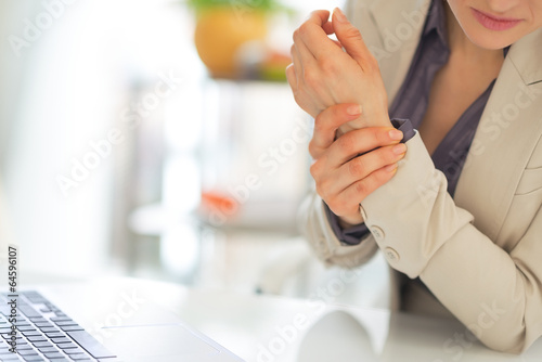 Closeup on business woman with wrist pain photo