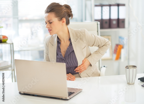 Tableau sur toile Business woman with stomach ache in office