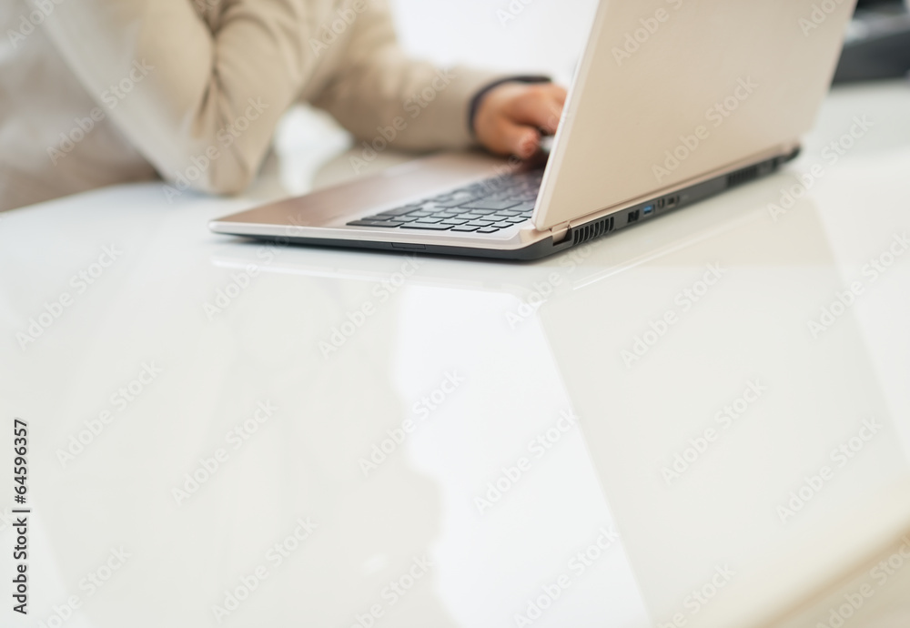 Closeup on business woman working on laptop Closeup on business woman working on laptop