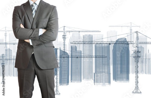 Businessman in suit. Tower crane and skyscrapers