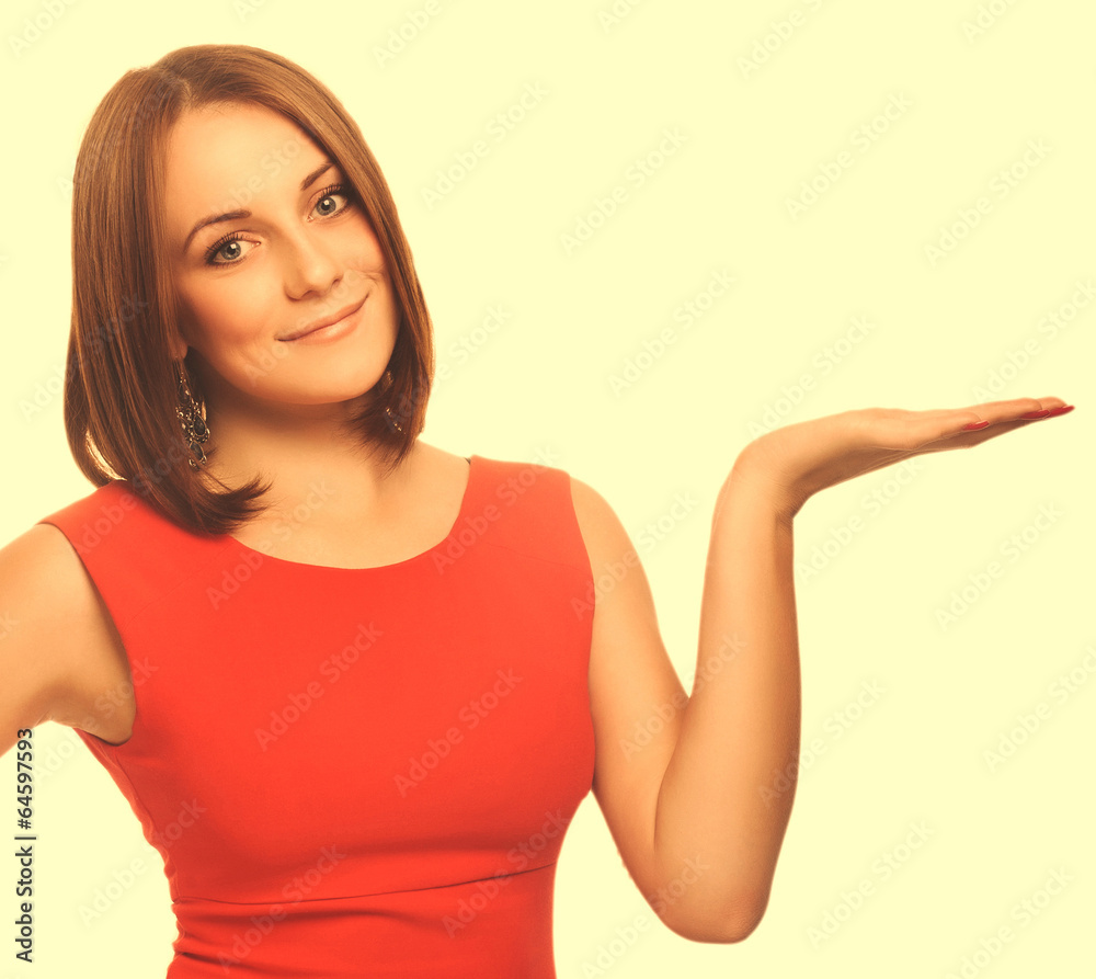 Fototapeta premium portrait happy young blond woman showing open hand holding in a