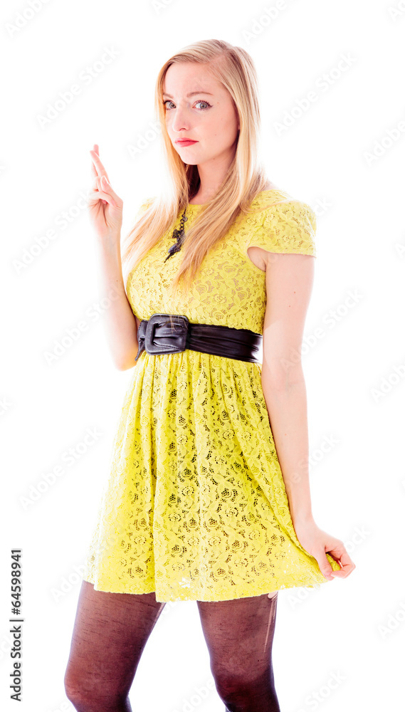 Beautiful young woman standing with her fingers crossed Beautiful young woman standing with her fingers crossed