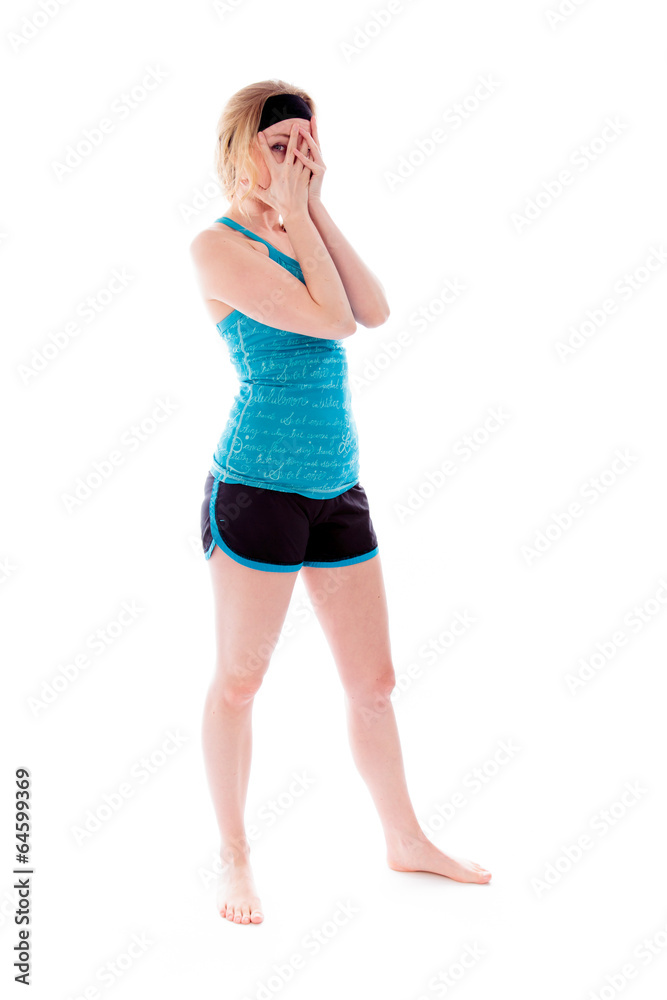 Young woman peeking through hands covering face Young woman peeking through hands covering face