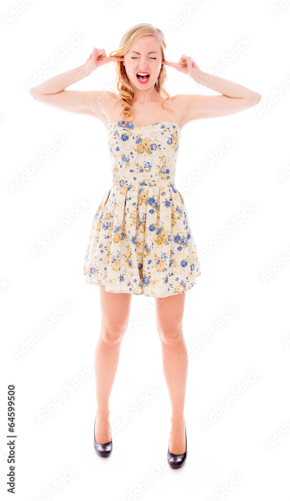 Young woman standing with fingers in her ears